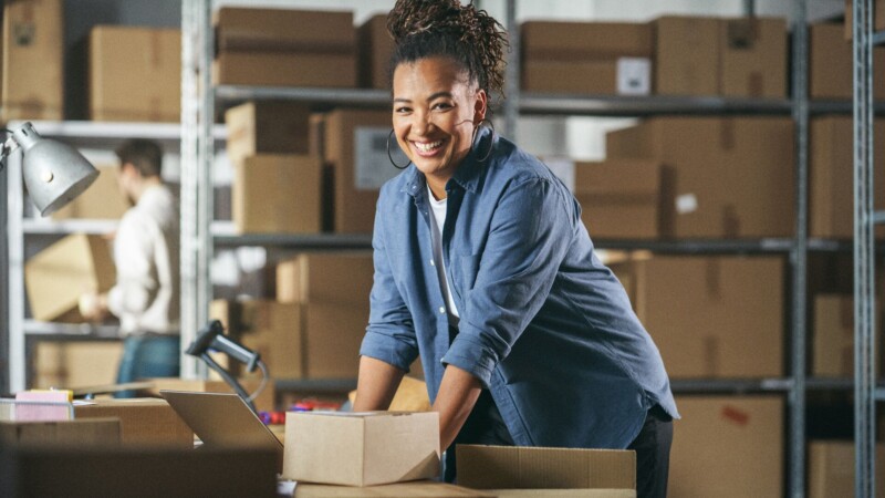 Smiling young woman in a shipping center